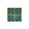 Photo shows a gift wrapped in whimsical hand illustrated wrapping paper - it has a festive mushroom pattern with various colorful mushrooms surrounded by greenery. The gift is wrapped with sparkly gold ribbon.