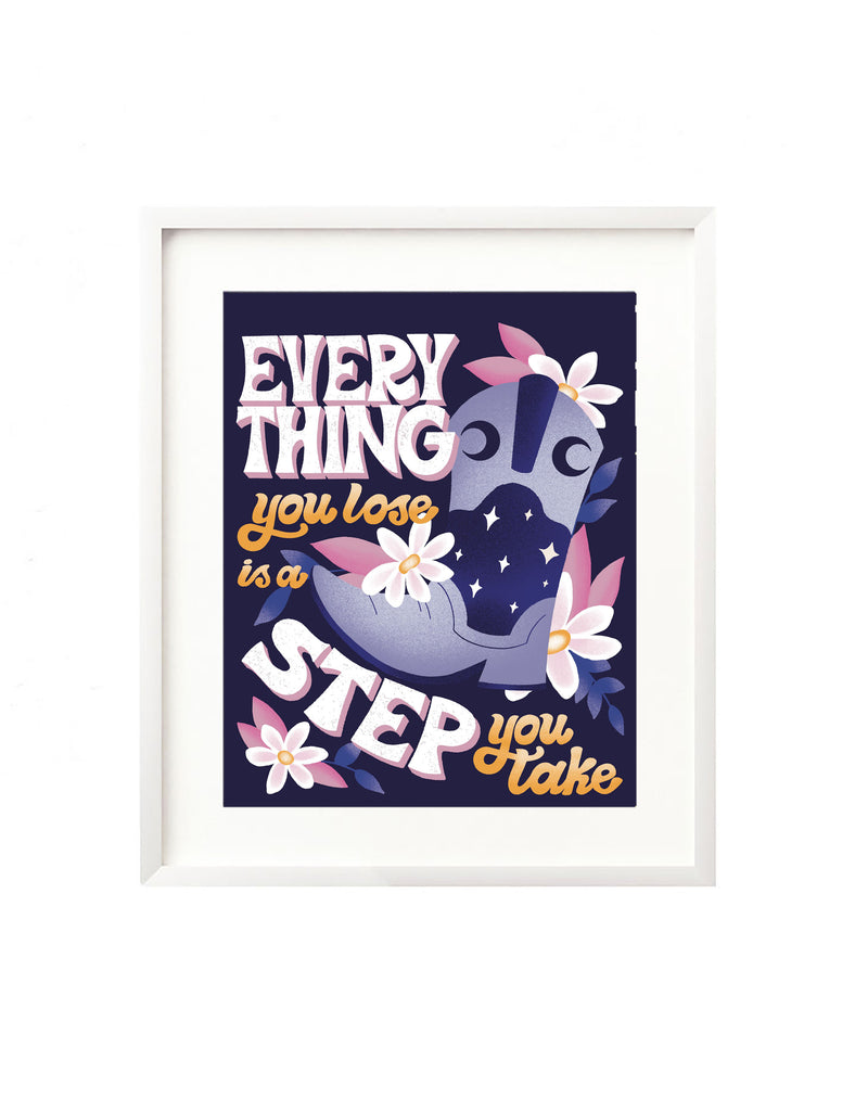 A framed art print - the illustration is of a cowgirl boot adorned with cosmic details like crescent moons and twinkling stars. It is surrounded by white and pink daisies and greenery. Hand lettered is "Everything you lose is a step you take" in a retro inspired style. Inspired by Taylor Swift's Song "You're On Your Own Kid" from the Midnights album.