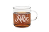 A mug is shown on a white background. It is a clear glass mug with white hand lettering that says "You are Magic" surrounded by whimsical clouds and twinkling stars.