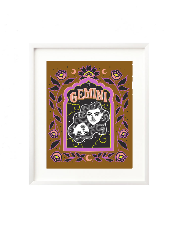 A framed art print - the illustration is a depiction of the Gemini zodiac sign. The two twins are floating in a celestial sky with whimsical moons and twinkling stars all around. Framed by folk art inspired florals with Gemini hand lettered at the top in a groovy, retro inspired style.