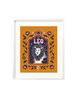 A framed art print - the illustration is a depiction of the Leo zodiac sign. The celestial lion is illustrated floating in a starry night sky, surrounded by whimsical clouds and framed in by folk art flowers. Leo is hand lettered at the top in a bold, groovy, retro inspired style.