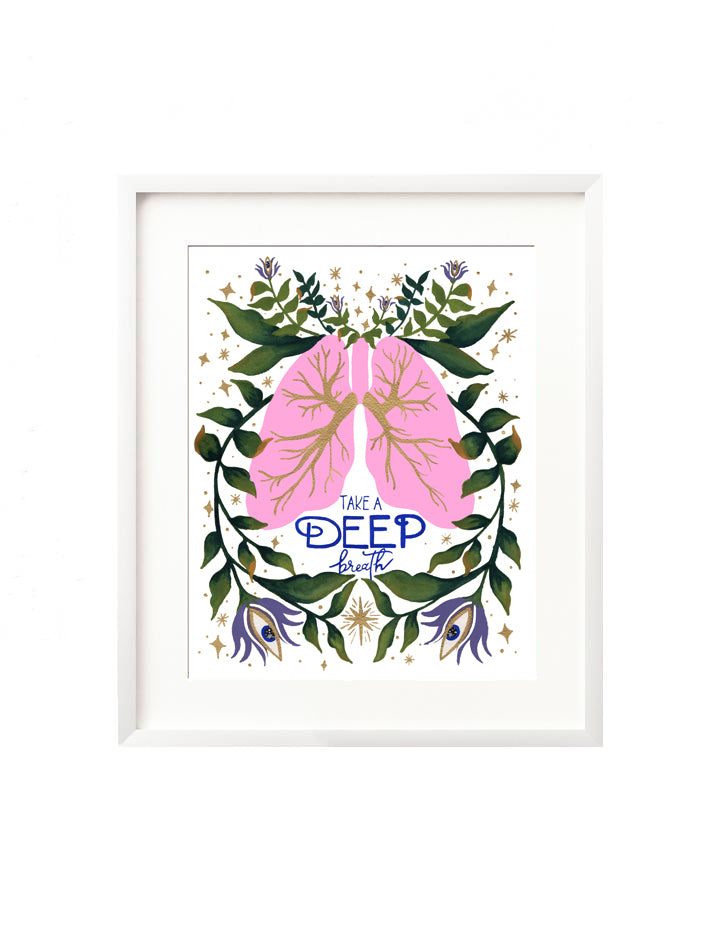 A framed art print - the illustration is a pair of pink lungs with vibrant florals and greenery being breathed out. There are twinkles and stars surrounding, and the hand lettered message "Take a deep breath". A reminder of the yoga principals of centering with your breath. The only moment is now.
